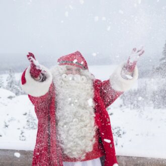 Santa Claus throwing snow in the air.