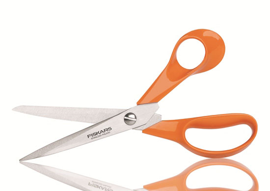 A pair of orange Fiskars scissors.