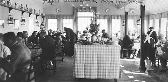 A black and white photo of a café.