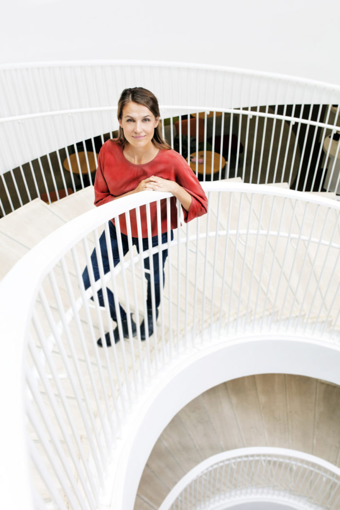 Maria Ritola posing in a spiral staircase.