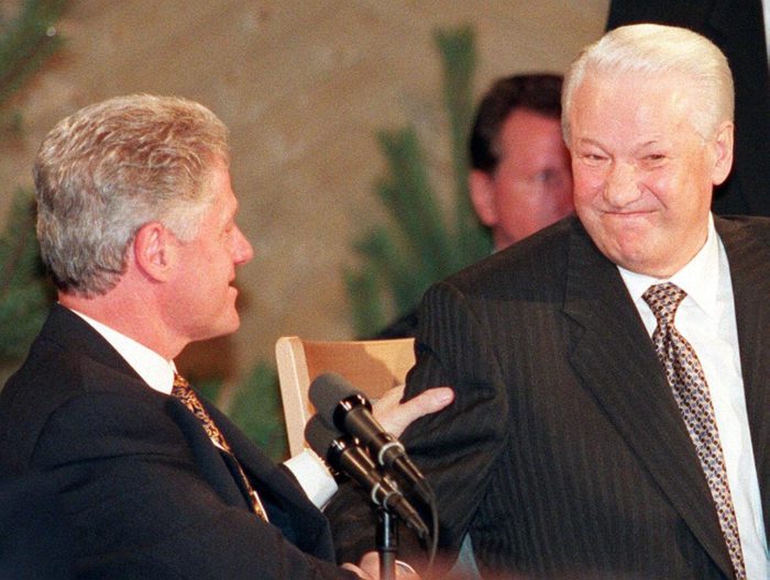 Bill Clinton squeezing the arm of Boris Yeltsin.