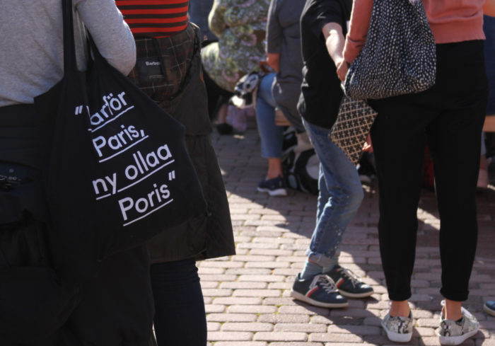 Crowd at Pori Areena; only their legs and bags are visible.