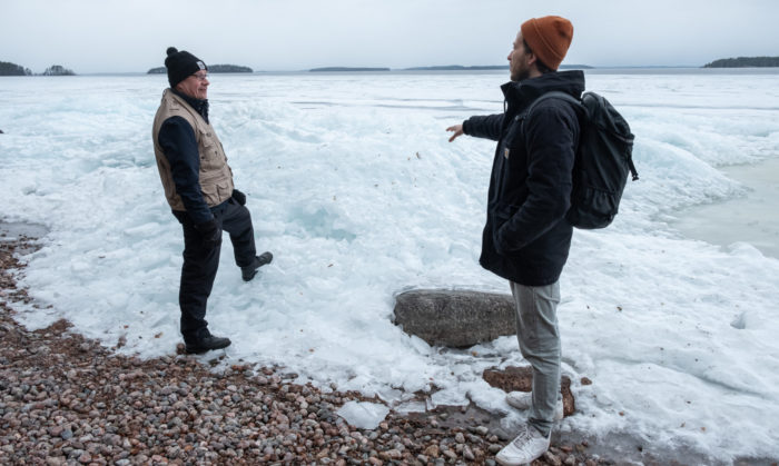 Joonas Fritze (right) of WWF Finland and Ismo Marttinen, a volunteer, survey the Saimaa lakeshore near Lappeenranta in southeastern Finland. The wind has broken the unusually thin lake ice and pushed it into jagged piles on the shore of a bay.