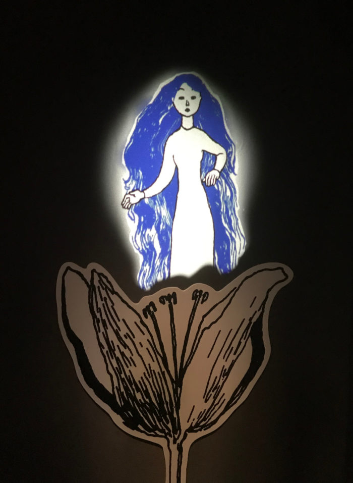 A drawing of a woman with long hair standing inside a flower.