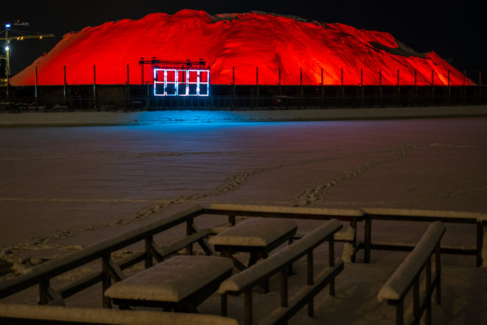 A large mound glows with red light.