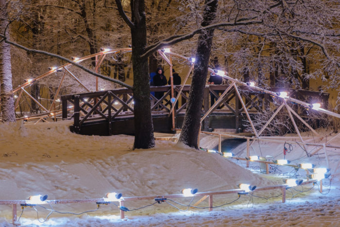 A track adorned with lamps curves through a park.