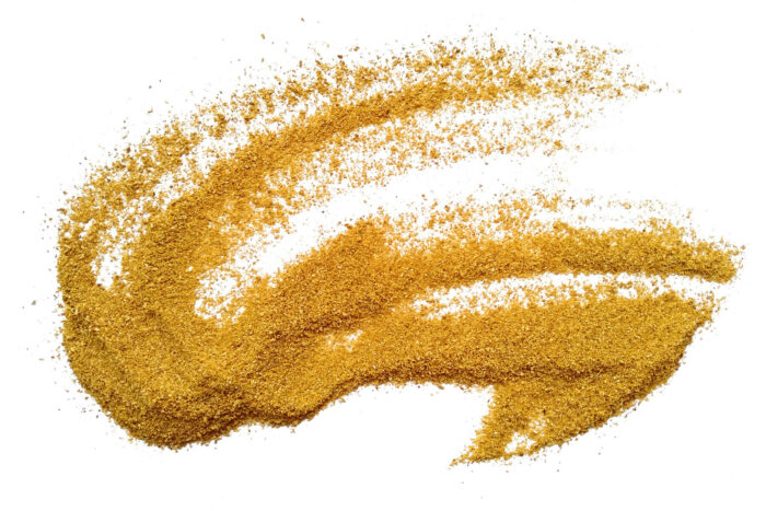 A pattern of granular brown powder on a white background.