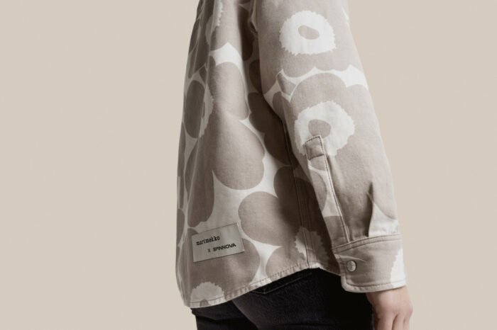 A person is wearing a shirt with a grey and white floral print.