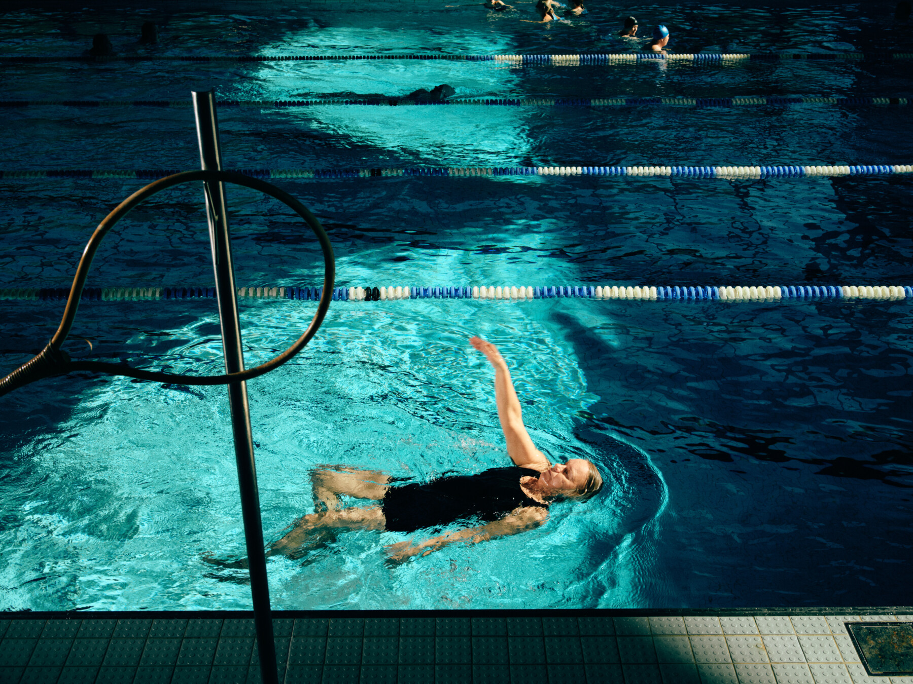 A woman swims in a pool.