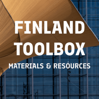 A curving wooden architectural element and a glass building facade are shown in this photo that links to Finland Toolbox, a webpage with materials and resources.