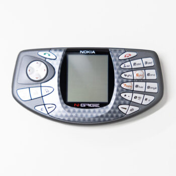 A grey gaming-style mobile device featuring a small display, directional buttons and a slanted number keypad.