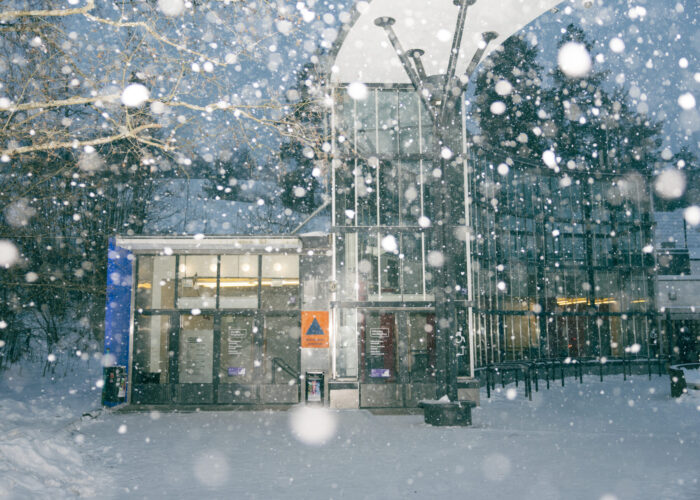 Snow falls heavily outside the glass entrance to the Itäkeskus underground shelter.