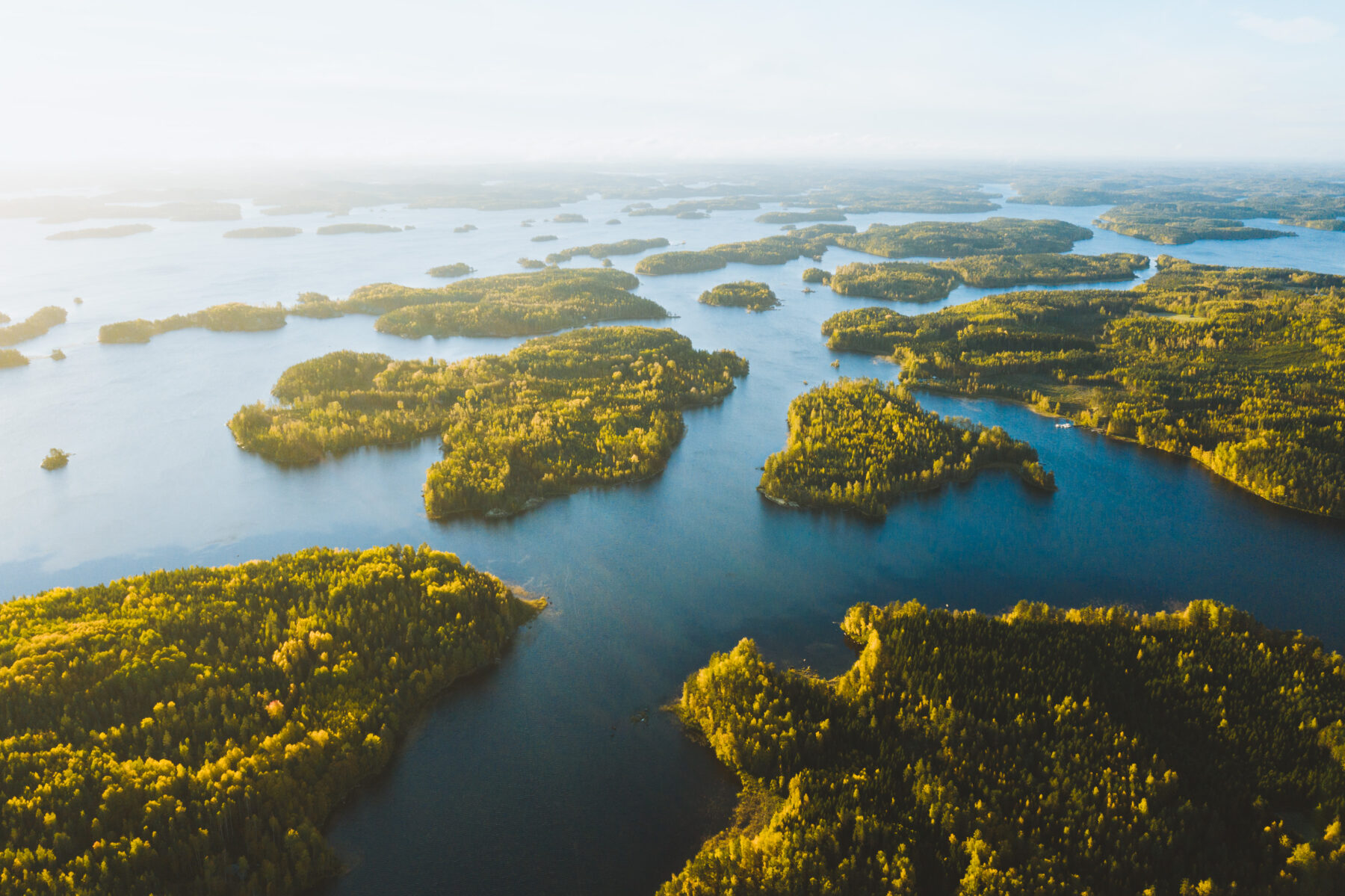 An aerial view shows part of a lake with myriad islands dotting its surface.