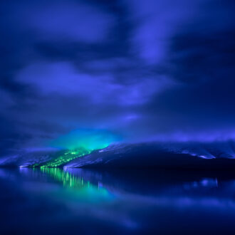 Colourful lights illuminate a mountainside and reflect on calm water during Finnish artist Kari Kola’s large-scale installation Savage Beauty in Connemara, Ireland.